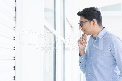 Asian man looking through the window