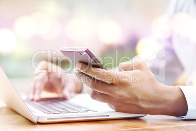 Man using smartphone and computer