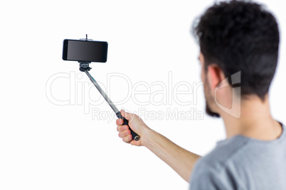 Casual man using a selfie stick