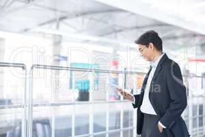 Man using tablet computer at railway station