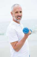 Fit man lifting dumbbells