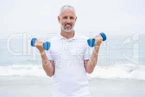 Fit man lifting dumbbells