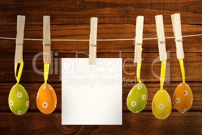 Composite image of hanging easter eggs