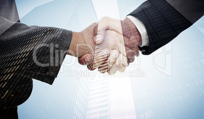Composite image of handshake between two business people