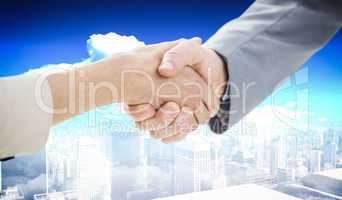 Composite image of closeup of shaking hands after business meeti