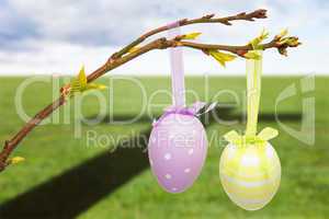 Composite image of hanging easter eggs