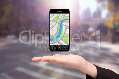 Composite image of hand showing map app on phone