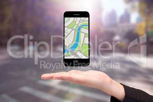 Composite image of hand showing map app on phone