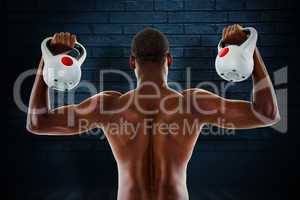 Composite image of rear view of shirtless fit man lifting kettle