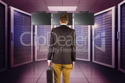 Composite image of young geeky businessman holding briefcase