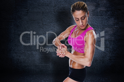 Composite image of female bodybuilder flexing in pink sports bra