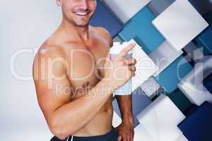 Composite image of bodybuilder holding flask