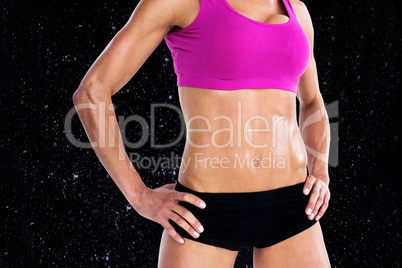 Composite image of female bodybuilder posing with hands on hips