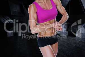 Composite image of female bodybuilder flexing in sports bra and