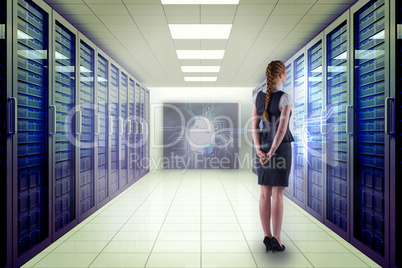 Composite image of redhead businesswoman with hands behind back