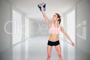 Composite image of female crossfitter lifting up kettlebell