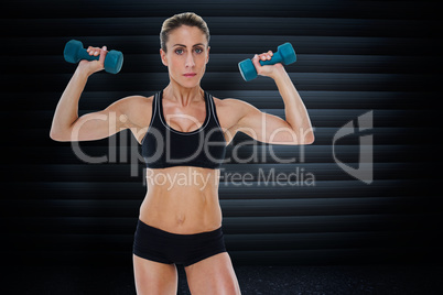 Composite image of female bodybuilder holding two dumbbells with