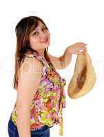 Woman holding her straw hat.