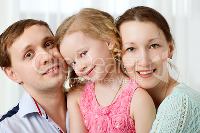 Happy young parents and little daughter