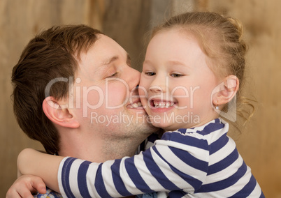 Happy father kissing little daughter