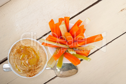 fresh hummus dip with raw carrot and celery