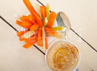 fresh hummus dip with raw carrot and celery