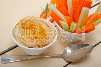 fresh hummus dip with raw carrot and celery