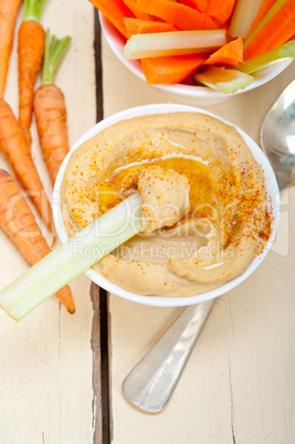 fresh hummus dip with raw carrot and celery