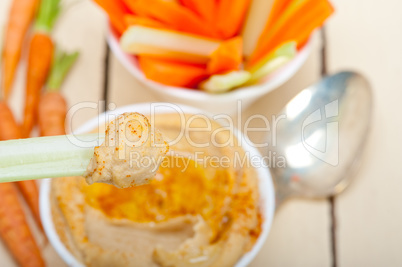 fresh hummus dip with raw carrot and celery