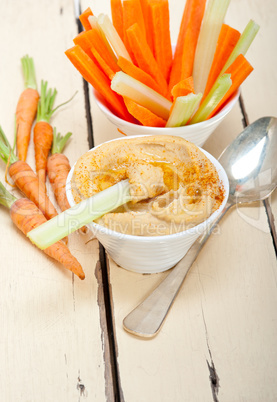 fresh hummus dip with raw carrot and celery