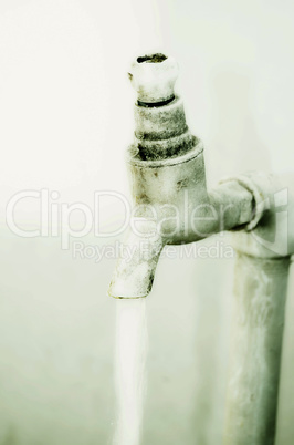 Tap of running water isolated on grey background
