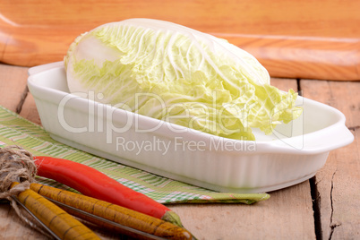 Cabbage on white bowl and red pepper
