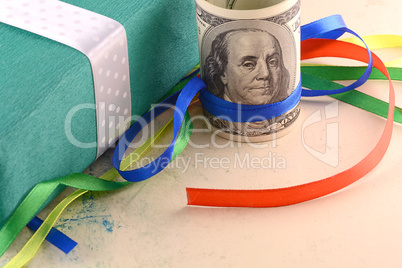 american money dollars and green gift box