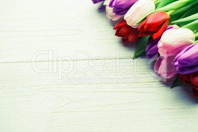 Colorful tulips on wooden table