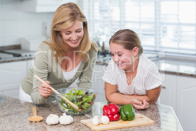 Mother and daughter preparing salad together