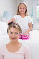 Daughter brushing her mothers hair