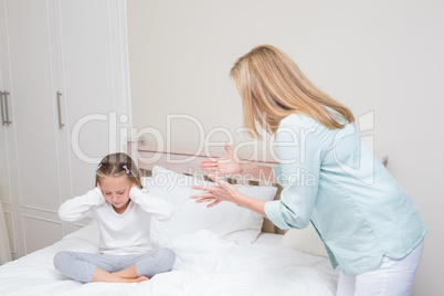 Upset mother scolding her daughter