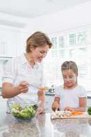 Mother and daughter preparing vegetables