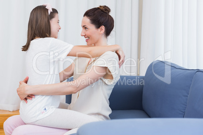 Mother and daughter smiling at each other