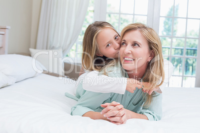 Cute girl kissing her smiling mother