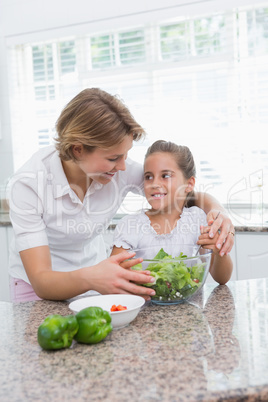 Mother and daughter preparing salad