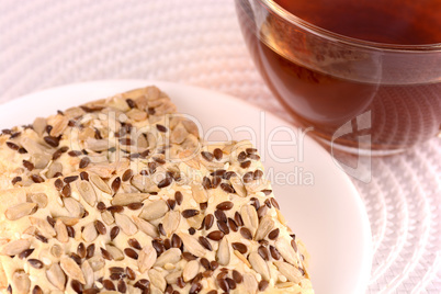 sweet cake on white plate with tea (coffee) cup