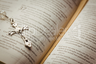 Open bible and silver crucifix