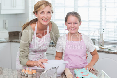 Mother and daughter making cake together