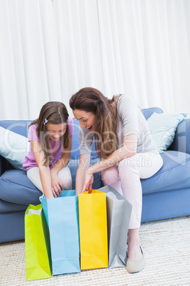 Mother and daughter looking at shopping bags