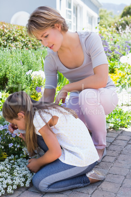 Mother and daughter tending to flowers