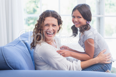 Happy mother and daughter having fun