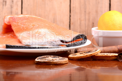 Slice of red fish salmon with fruits and cinnamon