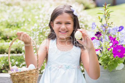 Happy girl collecting easter eggs