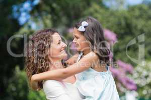 Happy mother and daughter smiling at each other